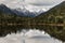 Souther Alps peaks reflecting in lake in New Zealand