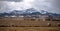 Southern Alberta mountains and praries with hay bales.