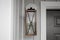 Southern Rustic Farmhouse Front Porch Light Sconce Next To Front Door and Grey Siding. Copyspace