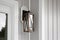Southern Rustic Farmhouse Front Porch Light Sconce Next To Front Door and Grey Siding. Copyspace