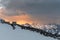 The southern slope of Mount Elbrus. Homemade shelters on the slope for the summit day at sunset against the backdrop of