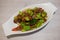 Southern Thai Style Stir Fried Twisted Cluster Bean with Crispy Pork on the boat like plate