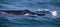 Southern whale swimming in the atlantic ocean near the coastline of the fynbos coast