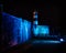 Southsea castle and lighthouse lit up by blue flood lights at night