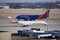 Southwest Airlines and American Eagle planes pass on the tarmac