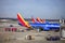 Southwest Airlines Planes Lined Up at Airport Gate Preparing for Departure