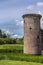 Southwest tower of Caerlaverock Castle under blue sky, Scotland