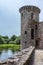 Southwest tower of Caerlaverock Castle under blue sky, Scotland