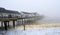 Southwold pier on a foggy day with the end disappearing into the mist.