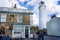 Southwold`s iconic lighthouse seen behind The Sole Bay Inn pub in Southwold, Suffolk, UK