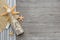 Souvenir bottle with sand and seashells on wooden background