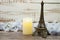 Souvenir Eiffel and Flameless Candles with flower decoration on wooden background