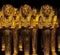 Souvenir figurines of stylized Egyptian images of buried pharaohs in yellow on  dark background