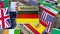 Souvenir magnet or badge with Munich text and national flag among different ones. Traveling to Germany conceptual 3D