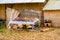 Souvenir for sale on the wooden table and a part of house made of Totora Reeds on The Floating Uros Island on the Lake Titicaca