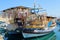 Souvenir shop organized on traditional Greek wooden boat at port of Rhodes town.