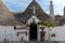 Souvenir shop in traditional white trulli house with conical roofs and painted symbols in Alberobello,