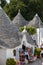 Souvenir shop in traditional white trulli house with conical roofs and painted symbols in Alberobello, Apulia