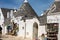 Souvenir shop in traditional white trulli house with conical roofs and painted symbols in Alberobello, Apulia