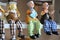 Souvenirs toys and vintage resin grandfather old man doll and retro grandmother senior woman on shelf for show in local gifts shop