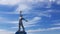 Soviet art statue of worker in powerful pose with sky background. Social realism monument in Odessa countryside of Ukraine.