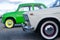 Soviet cars. side view of the front wheels. green and beige cars