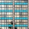 Soviet constructivist industrial building exterior facade with large windows, blue glass bricks