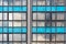 Soviet constructivist industrial building exterior facade with large windows, blue glass bricks