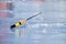 Soviet fishing rod for winter fishing stands on the ice near the ice hole