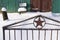 Soviet five finger star on a fence door background an old wooden fence