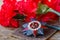 Soviet order of Patriotic War inscription Patriotic war with red carnations on an old wooden table. May 9 day of victory in the