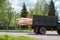 Soviet ZIL truck tramsports wooden building materials, still on move, lumber, body, engine on gas
