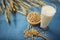 Soy beans , soy milk in glass and wooden spoon blue floor