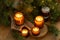 Soy candles burn in glass jars. The evening is dark. Aromatherapy and relaxation. Comfort at home. Candle in a brown jar