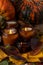 Soy candles burn in glass jars. Tree leaves, pumpkin. Comfort at home. Candle in a brown jar. Scent and light. Scented