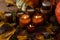 Soy candles burn in glass jars. Tree leaves, pumpkin. Comfort at home. Candle in a brown jar. Scent and light. Scented