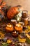 Soy candles burn in glass jars. Tree leaves, pumpkin. Comfort at home. Candle in a brown jar. Scent and light. Scented