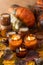 Soy candles burn in glass jars. Tree leaves, pumpkin. Comfort at home. Candle in a brown jar. Scent and light. Scented