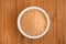 Soy lecithin in a bowl on a wooden background