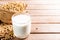 Soy milk in a glass with soybeans on a wooden table Organic breakfast, high protein, healthy, agricultural products, vegetarian