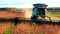 Soybean harvest. A combine harvester in a field harvests soybeans at sunset. Agriculture in the fields.