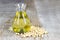 Soybean oil in glass jar and soybean on the wooden background