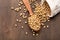 Soybeans scattered on rustic table with wooden spoon