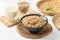 Soybeans seed in a black bowl with spoon and soy milk