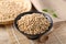 Soybeans seed in a black bowl on wooden background