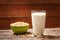 Soybeans and soy milk in a glass on wood background