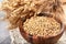 Soybeans in wooden bowl on light background