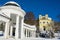 Spa architecture in winter - colonnade of mineral spring Karolina and catholic church - Marianske Lazne Marienbad