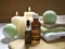 Spa aromatherapy still life with bath bombs, essential oil bottles and lit candles on wooden background.