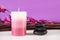 Spa background concept with aromatic candle and black stones